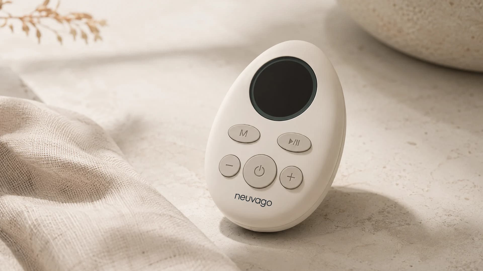Close-up of the Neuvago handheld device in a warm premium product composition.